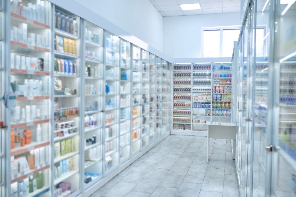 Pharmacy shelves stocked with medicines ready for controlled delivery