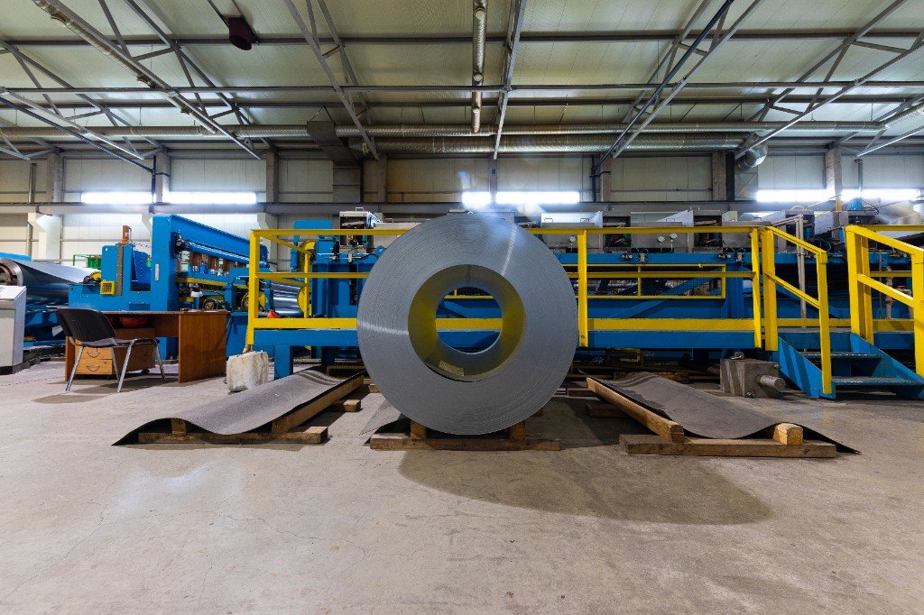 Steel coil and production equipment inside a manufacturing facility